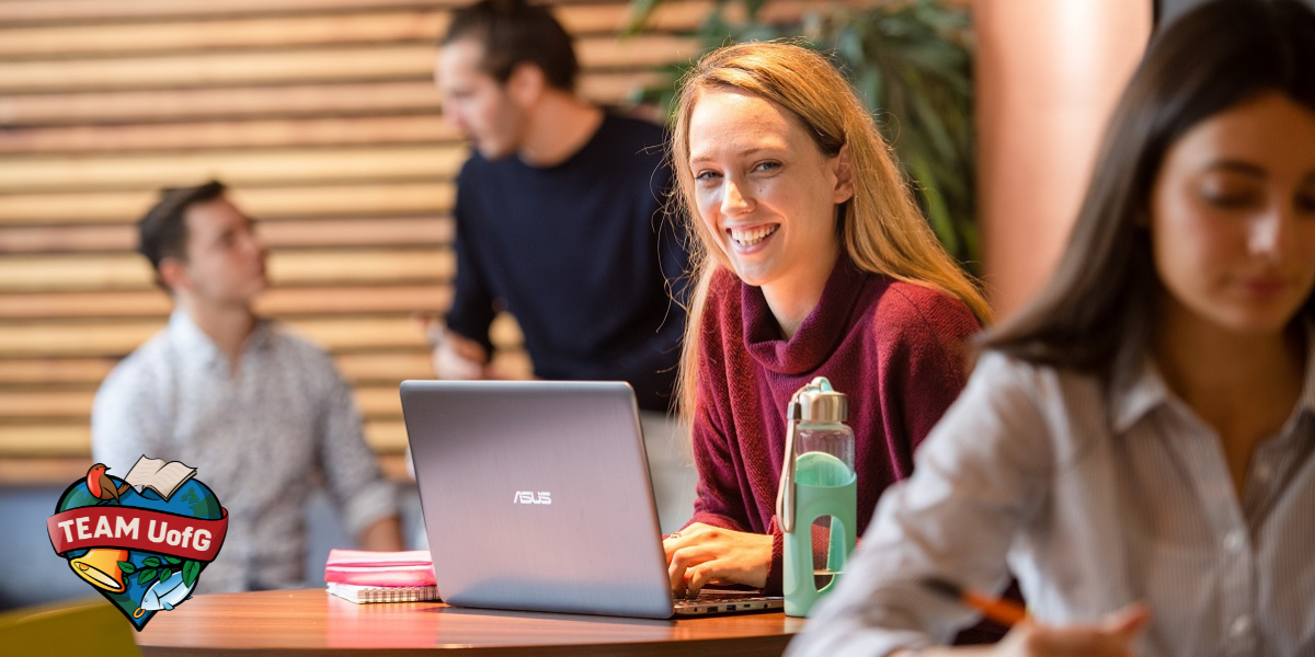 female student in library with laptop