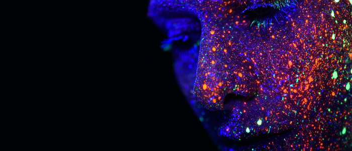 A face with light patterns projected onto it