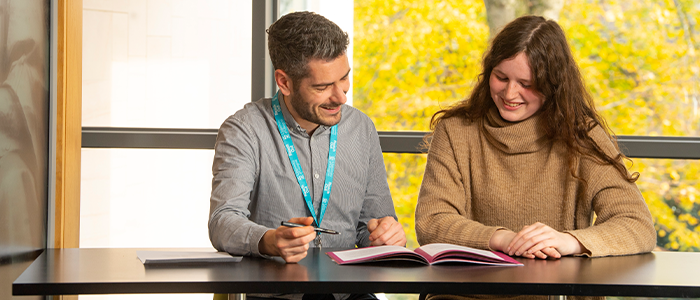 Student accessing support services sitting at a desk