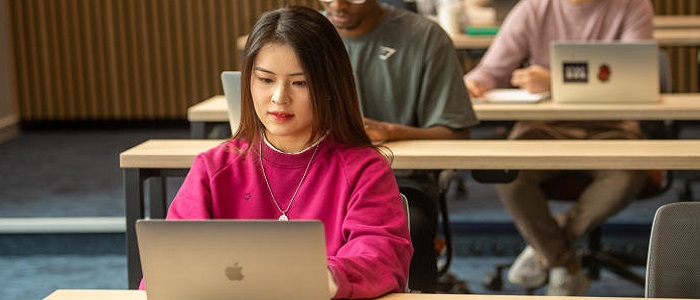 A young Asian woman using a laptop computer in a lecture room. Source: Glasgow University Image Bank https://cameralibrary.gla.ac.uk:8095/restricted/#/login