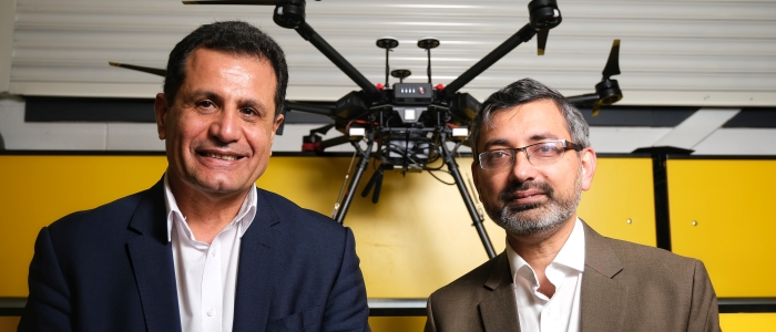 Two academics sitting with a drone