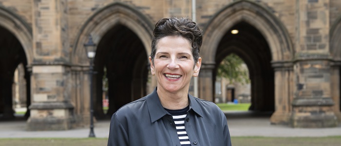 An image of Professor Jenifer Smith in front of the Cloisters