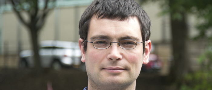 Dr Iain Martin head shot with outdoor background.