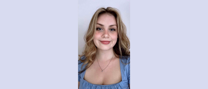 Young woman with long blonde hair smiling at the camera 