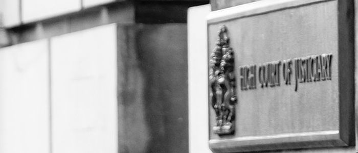 Black and white close-up of the high court sign in Edinburgh