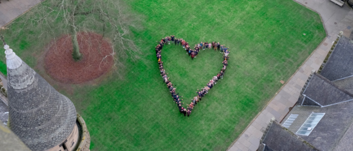 Aerial photo of the East Quadrangle, with students grouped in the shape of a heart.