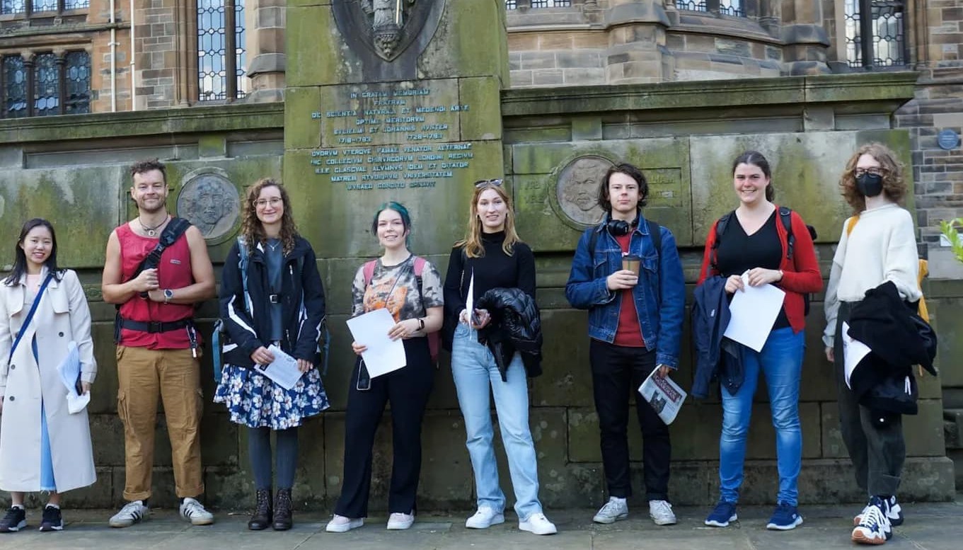Students standing in front of Gilbert Scott Building