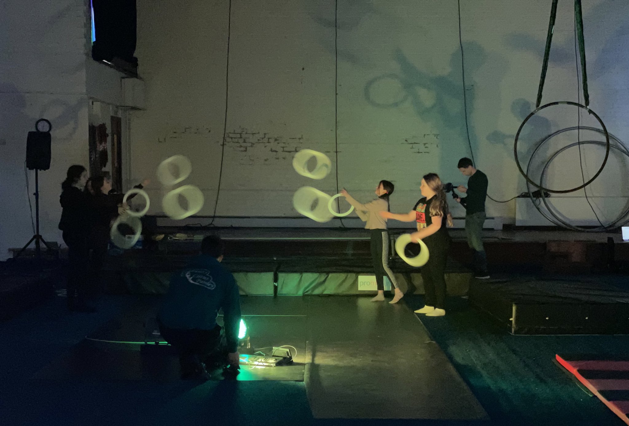 young people juggling with yellow rings