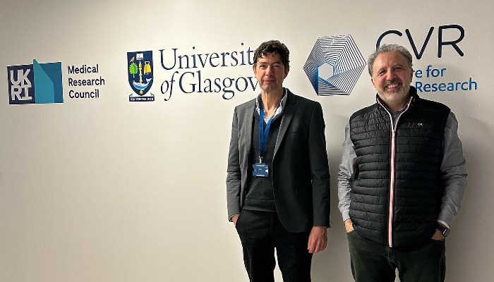 2022 CVR Stoker Award Winner Professor Christian Drosten stood beside CVR Director Professor Massimo Palmarini under the CVR logo 