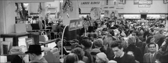 Photograph of customers browsing the sale items during the winter sale, c1960. (GUAS Ref: HF 51/6/1/5/3 photo 2. Copyright reserved.)
