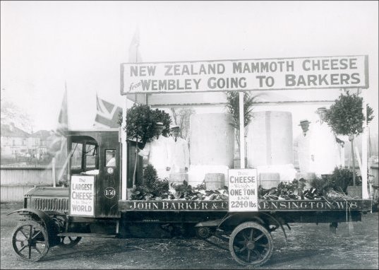 Mammoth New Zealand Cheese. Purchased by John Barkers from the Wembley exhibition: Cheeses loaded ready for transportation to the store in Kensington, 1924. (GUAS Ref: HF 51/8/1/1/3 photo 13. Copyright reserved.)