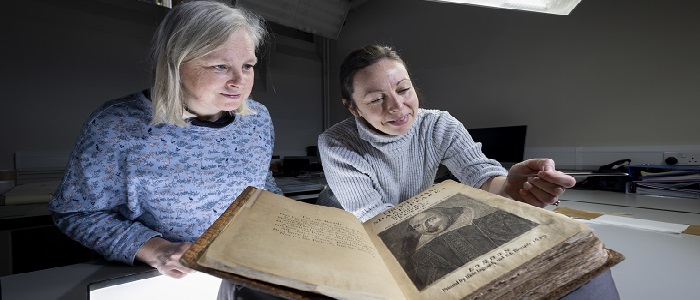Lleft to right: Julie Gardham, Senior Assistant Librarian, and Keira McKee, Book Conservator, with the University of Glasgow’s First Folio. Credit Martin Shields