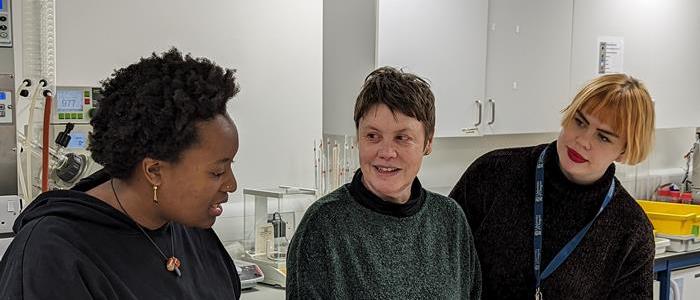 Researchers from the Kelvin Centre in the lab examining historical dyes in a textile sample