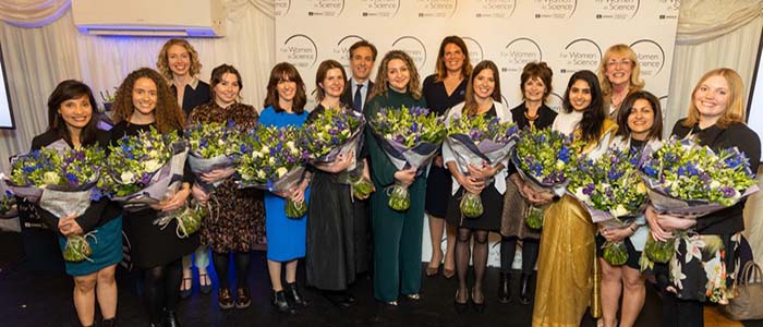 Images of shortlisted candidates at the House of Commons holding flowers in a group