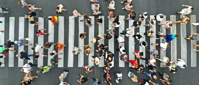 An aerial picture of many people on a zebra crossing