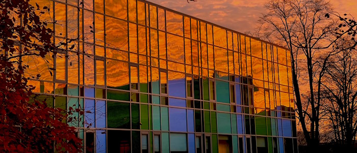 Fraser building at sunrise reflecting red light on windows