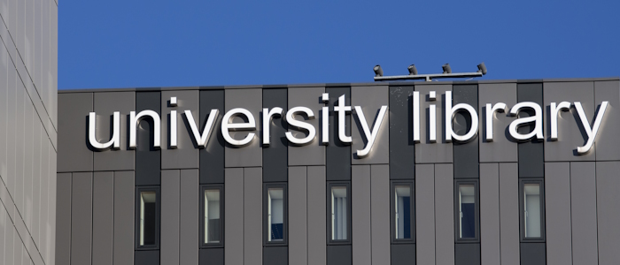 university library sign on the outside of the library building