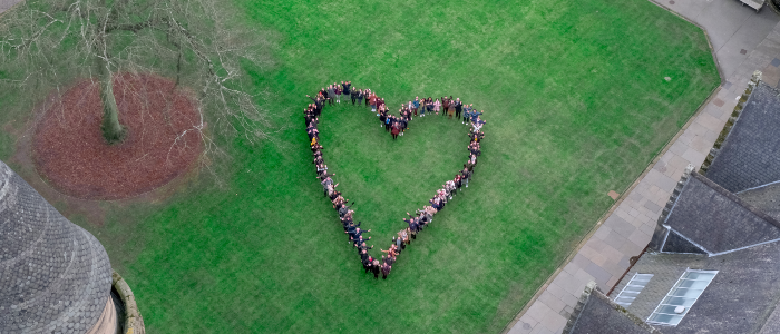 Aerial photo of the UofG East Quadrangle, with students grouped in the shape of a heart.