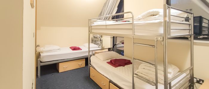 Slack building accommodation room showing bunk beds and one single bed