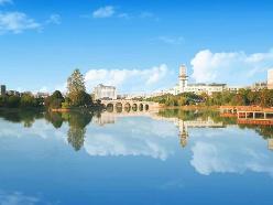ZUEL campus building reflected in water