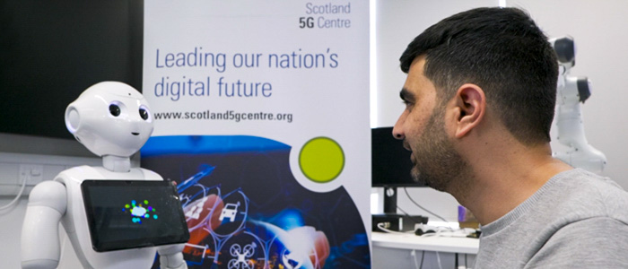 A researcher looking at a 5G enabled robot