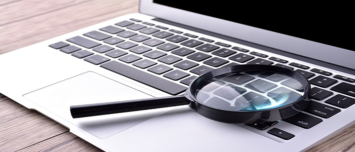 Laptop & magnifying glass