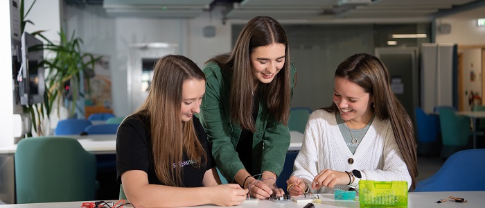 Three engineering students at desk